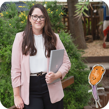 Woman in business attire holding a laptop stands outdoors near greenery; a child-like drawing of a person is added to the bottom right-hand corner of the image.