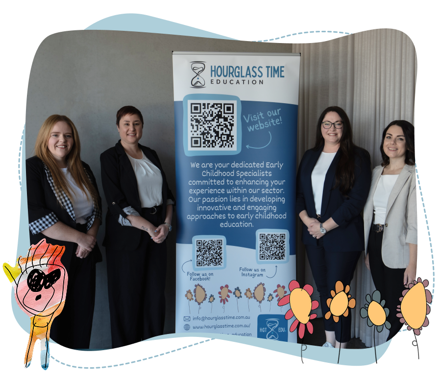 Four women in business attire stand beside an “Hourglass Time Education” banner about early childhood education, with children’s artwork decorations framing the photo.