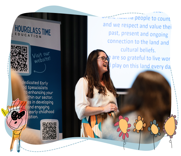 A woman stands and speaks in front of a screen and a blue “Hourglass Time Education” banner, with audience members and flower illustrations in the foreground.