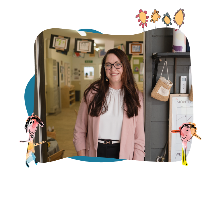 A woman in a pink blazer stands smiling in a doorway, with children’s drawings and artwork displayed on the walls and cartoon figures framing the image.